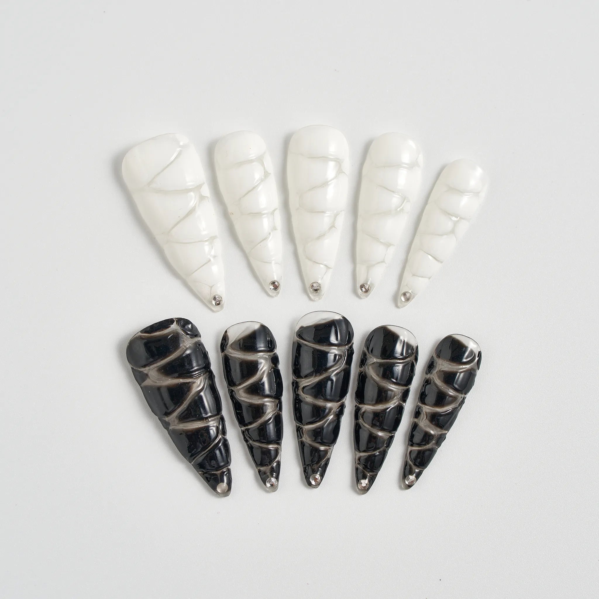 Set of black and white decorative cones on a light gray background