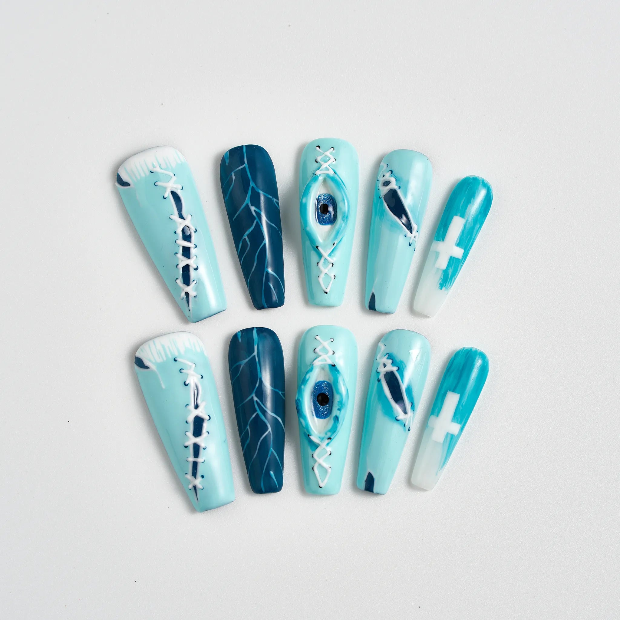 Set of blue and white nail art designs on a light gray background
