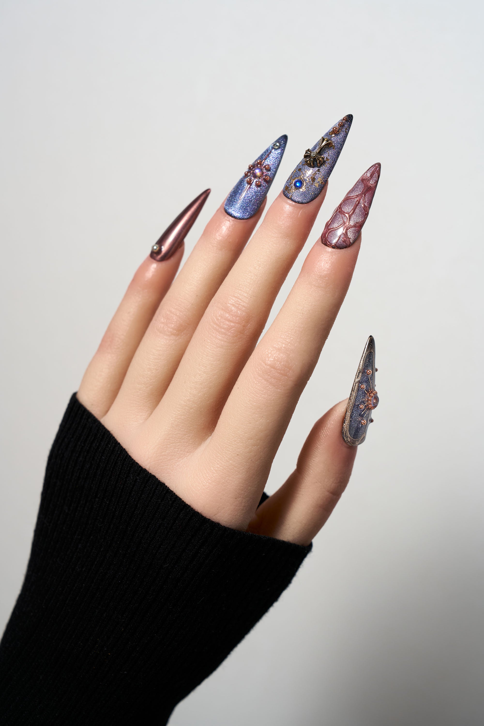 Violet Eclipse stiletto reusable press-on nails with a purple cat-eye finish, featuring gothic 3D metallic charms, celestial motifs, and copper-toned accents for a mystical look.