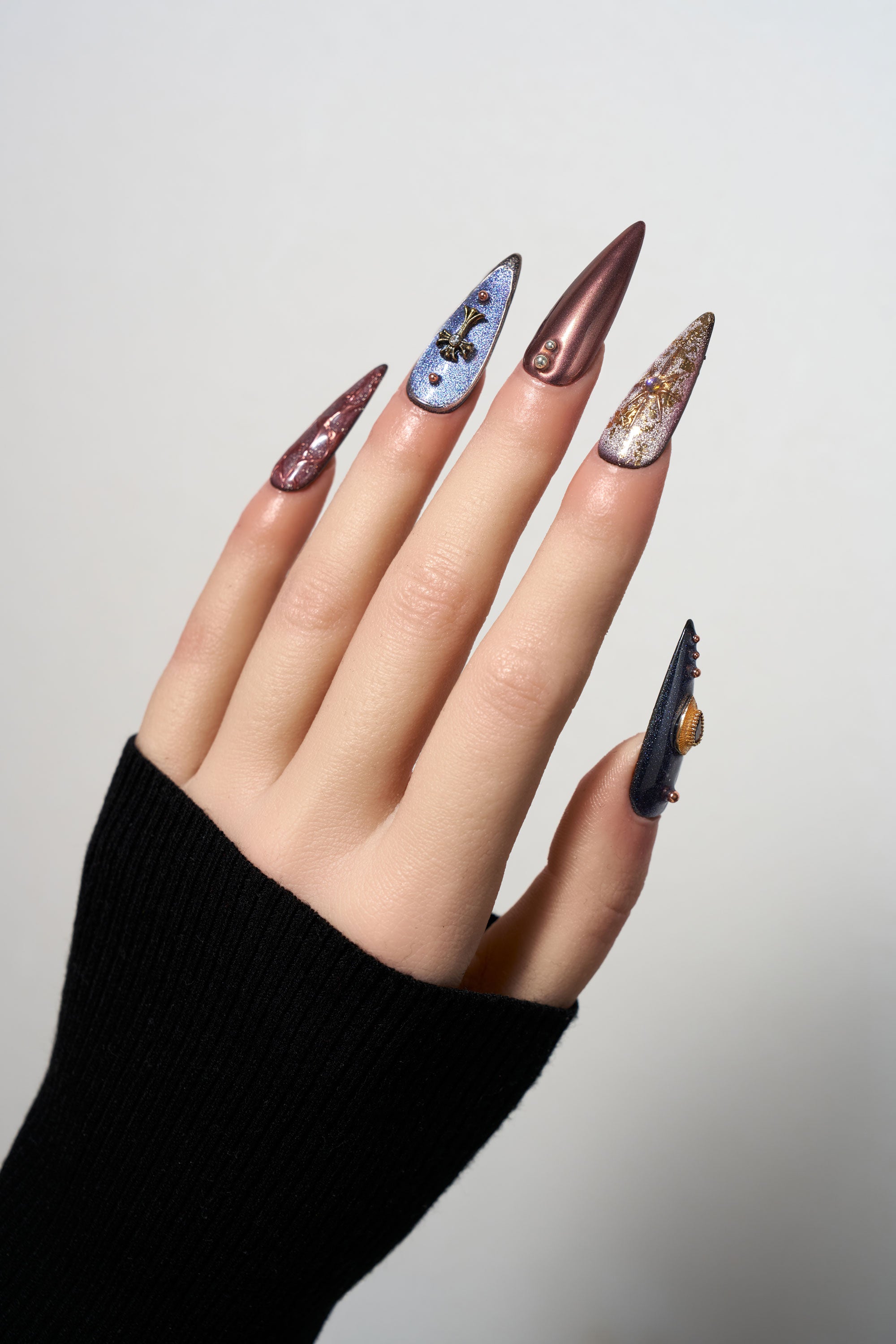 Violet Eclipse stiletto reusable press-on nails with a purple cat-eye finish, featuring gothic 3D metallic charms, celestial motifs, and copper-toned accents for a mystical look.