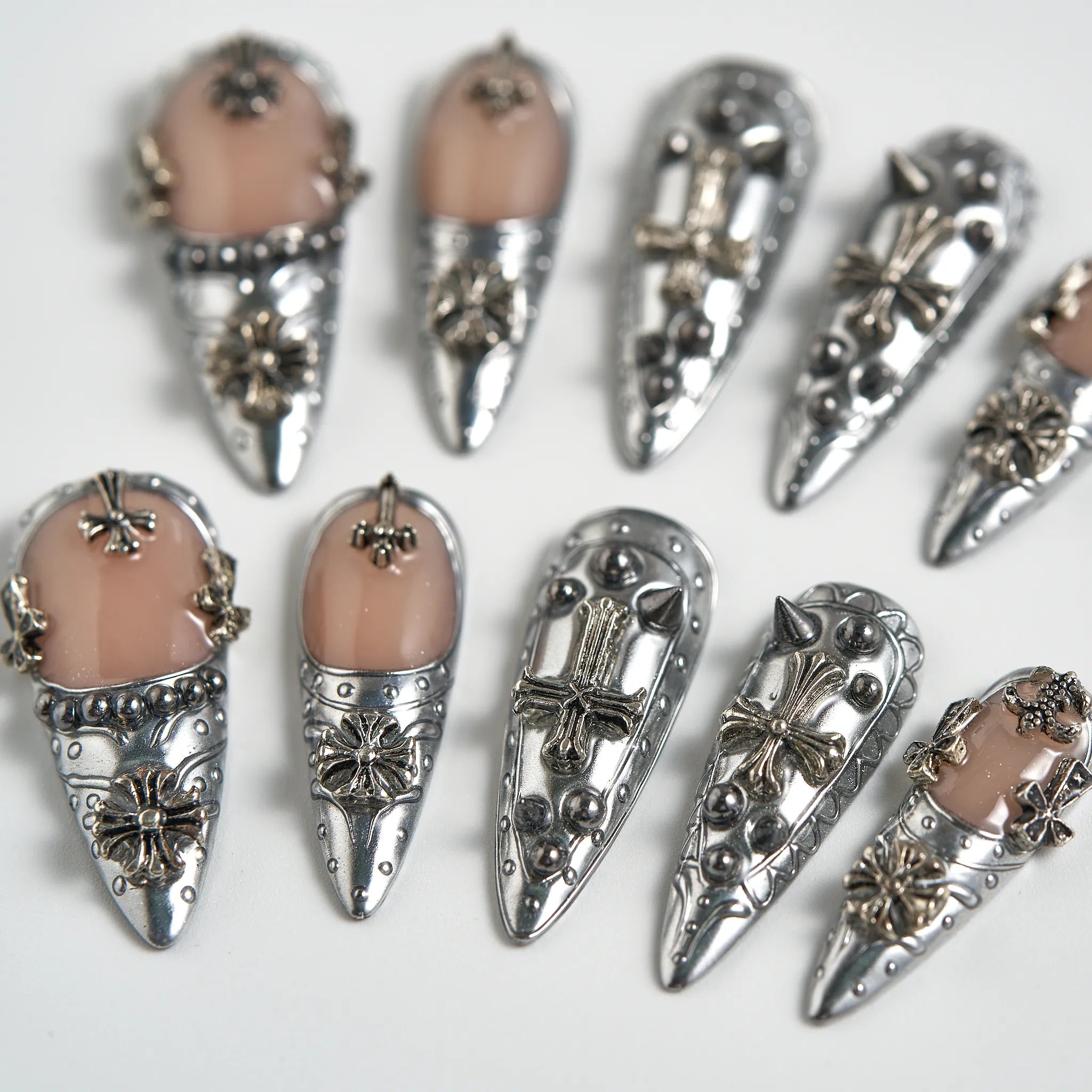 Decorative silver and pink earrings on a white background