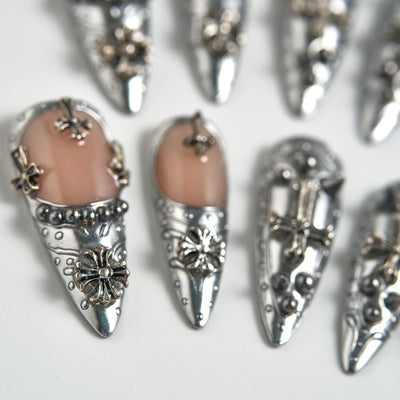 Decorative silver pendants with pink stones on a light background