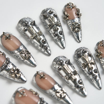 Chrome Reign stiletto press-on nails in metallic chrome silver, close-up showing 3D art accents, reusable salon-quality nails on white background