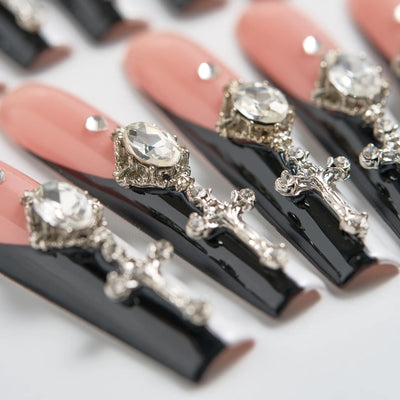Black lipsticks with decorative silver tops on a white background