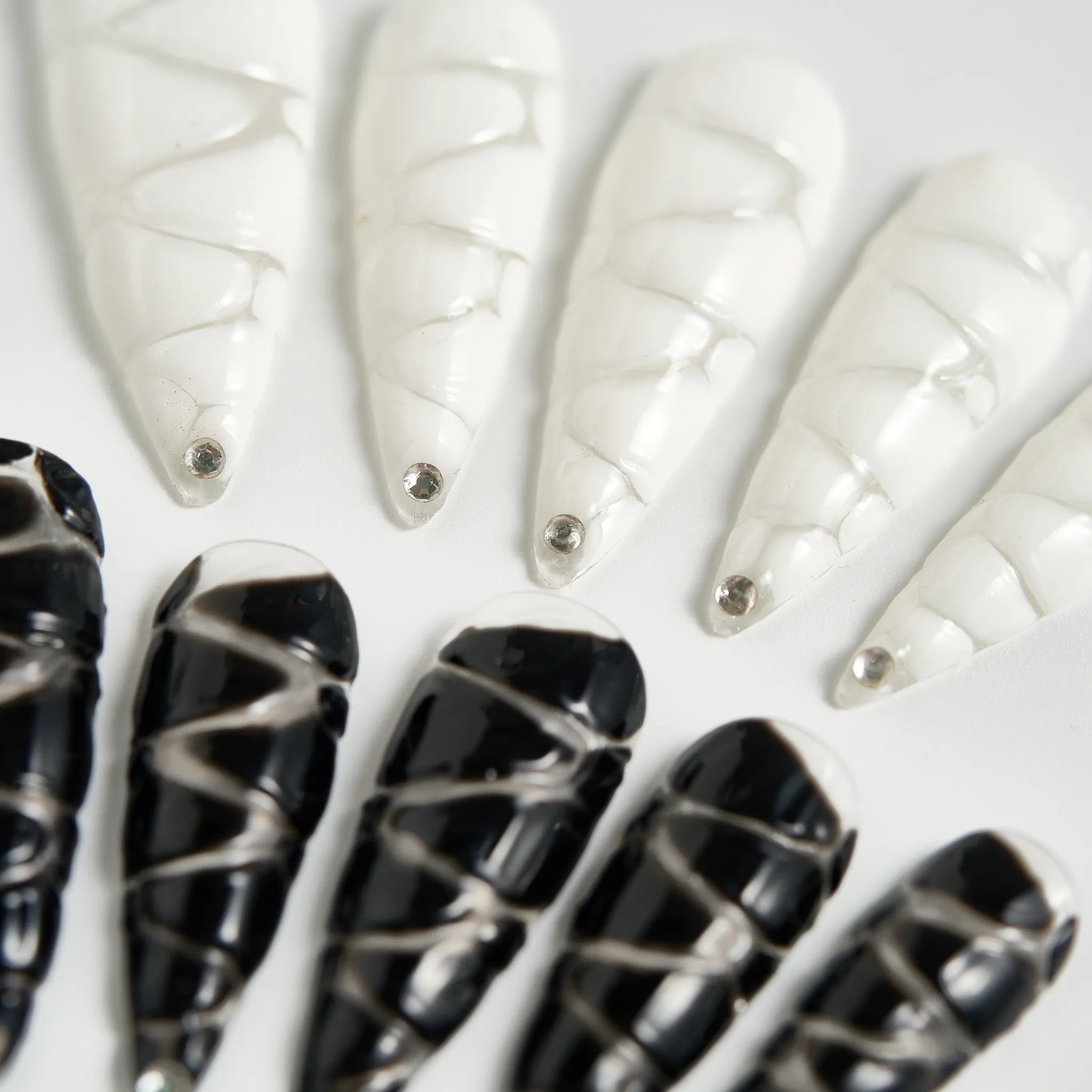 Black and white nail art designs on a white background