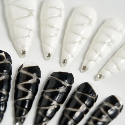 Black and white nail art designs on a white background