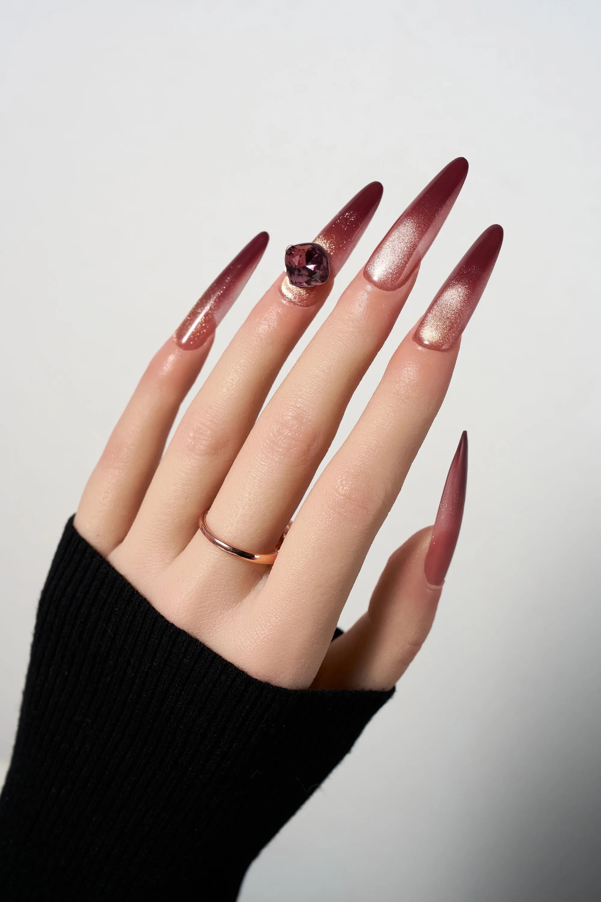 Rosé Garnet reusable extra-long stiletto press-on nails featuring a deep burgundy to rose gold ombre cat-eye effect, highlighted by a massive centerpiece purple square-cut gemstone.