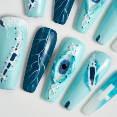 Blue and white nail art designs on a light gray background