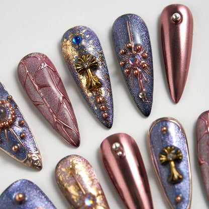 Detail view of Violet Eclipse metallic purple and gold stiletto reusable press-on nails, showcasing nail art with charms