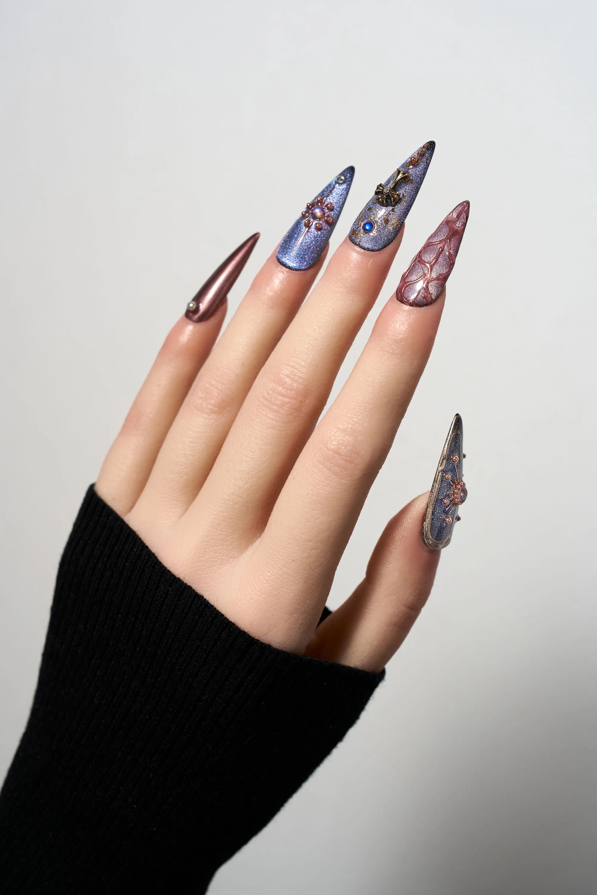 Violet Eclipse stiletto reusable press-on nails with a purple cat-eye finish, featuring gothic 3D metallic charms, celestial motifs, and copper-toned accents for a mystical look.